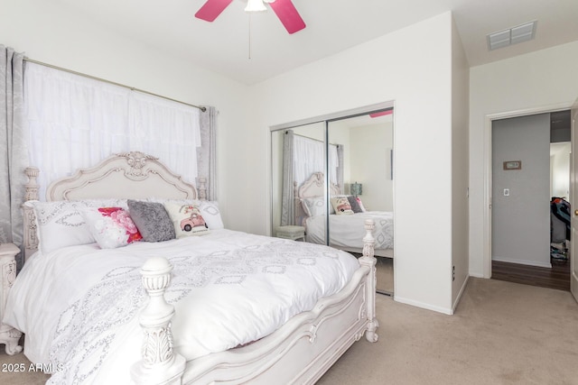 14363 W Acapulco Ln, Surprise, AZ 85379 - bedroom featuring light colored carpet, baseboards, visible vents, a ceiling fan, and a closet