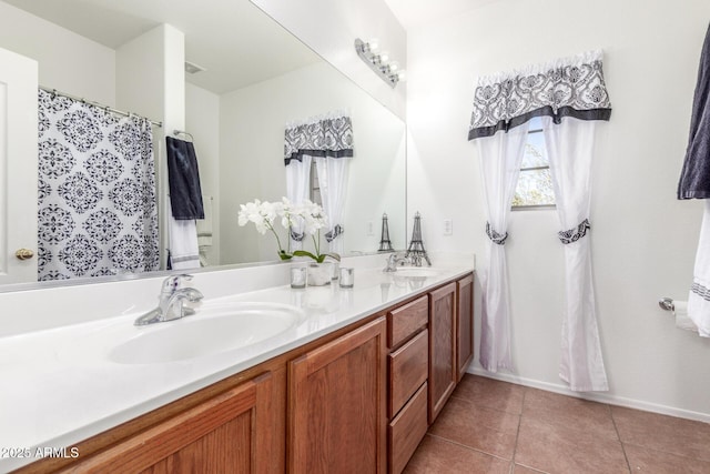 14363 W Acapulco Ln, Surprise, AZ 85379 - full bath with baseboards, tile patterned floors, a sink, visible vents, and double vanity