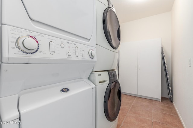14363 W Acapulco Ln, Surprise, AZ 85379 - washroom with light tile patterned flooring, baseboards, and stacked washing maching and dryer