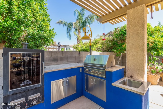 14363 W Acapulco Ln, Surprise, AZ 85379 - view of patio / terrace featuring fence, exterior kitchen, area for grilling, and a pergola