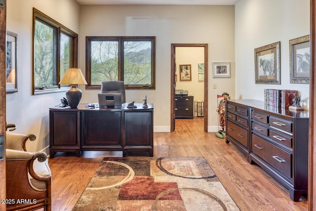 office area with baseboards and light wood-style floors