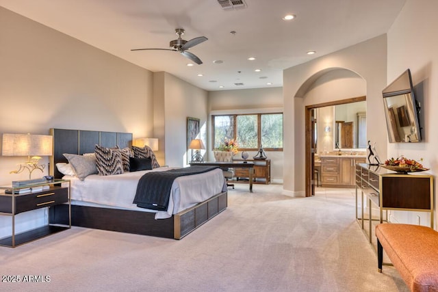 bedroom featuring visible vents, recessed lighting, connected bathroom, baseboards, and light colored carpet