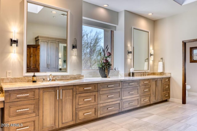 full bathroom with double vanity, toilet, visible vents, and a sink