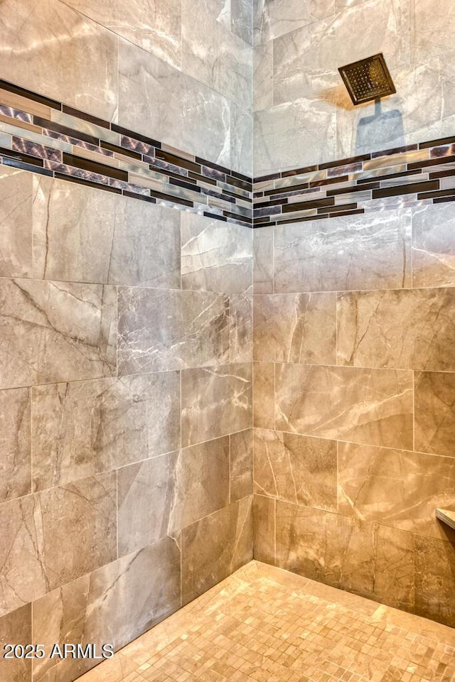 interior details with a tile shower