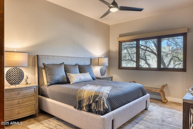 bedroom featuring ceiling fan and baseboards