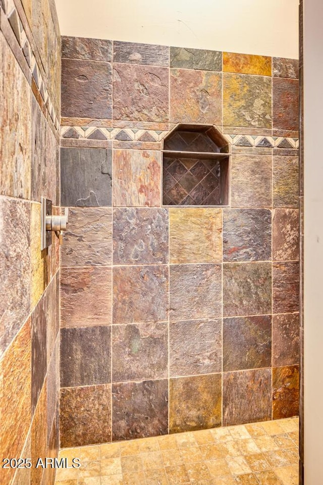 interior details featuring a tile shower