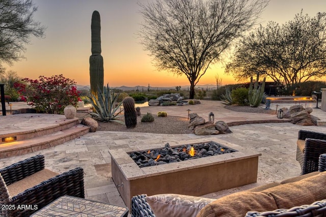 patio terrace at dusk with a fire pit