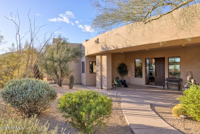 exterior space with a patio and stucco siding