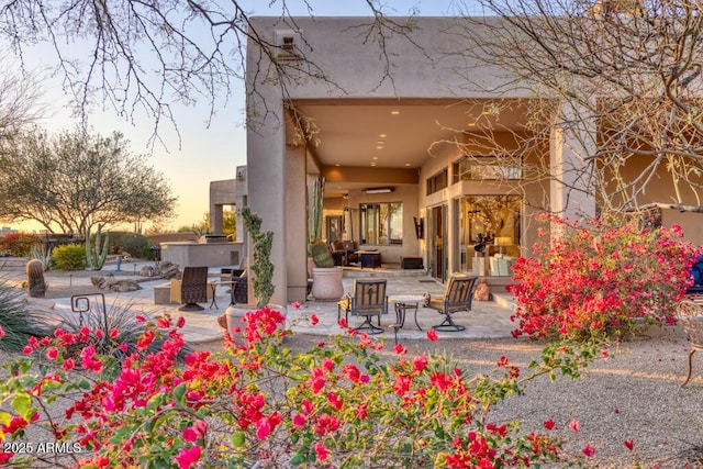 view of patio terrace at dusk