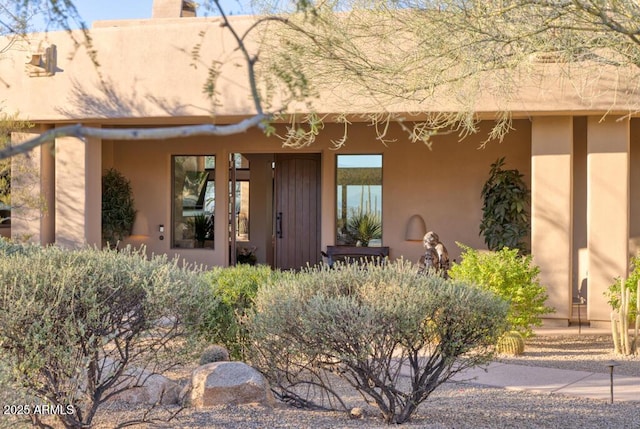 entrance to property with a chimney