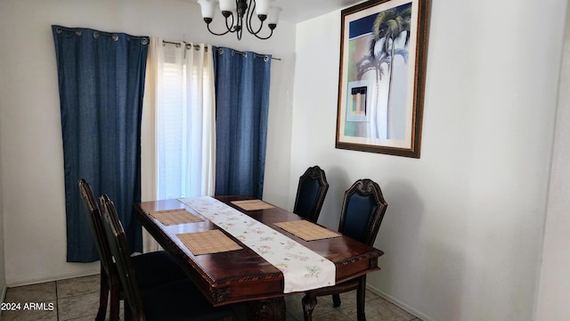 tiled dining space featuring an inviting chandelier