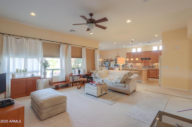 living room with recessed lighting, visible vents, and a healthy amount of sunlight