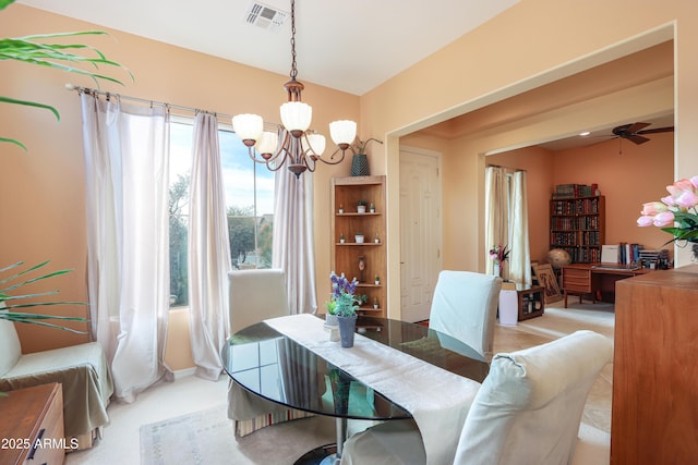 dining room with ceiling fan with notable chandelier and visible vents