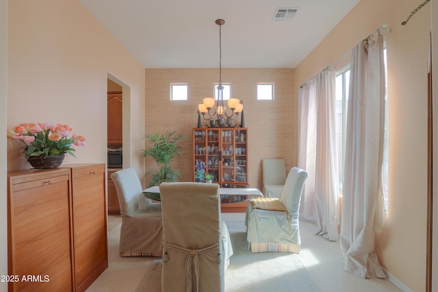 dining area with a chandelier and visible vents