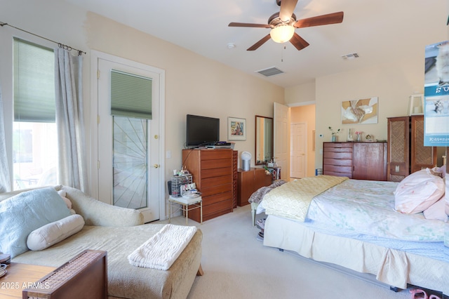 bedroom with ceiling fan, visible vents, and light colored carpet