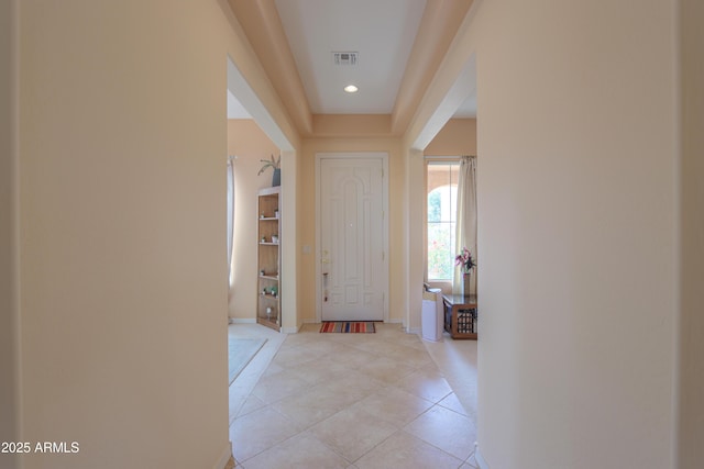 entryway with visible vents, baseboards, and light tile patterned floors