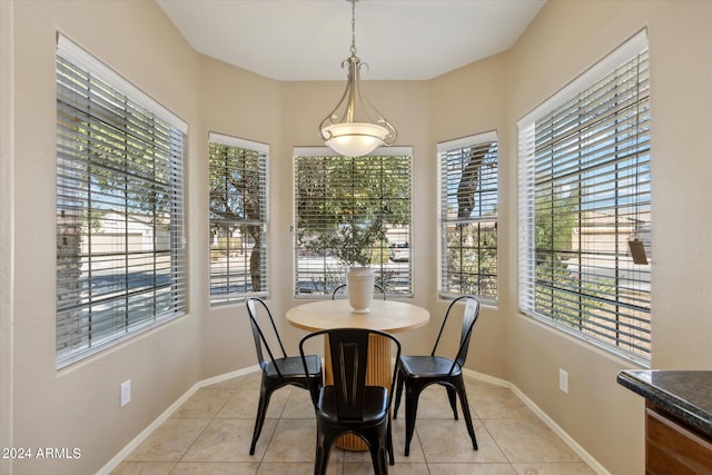 tiled dining space with a healthy amount of sunlight