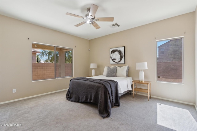 bedroom with light colored carpet and ceiling fan