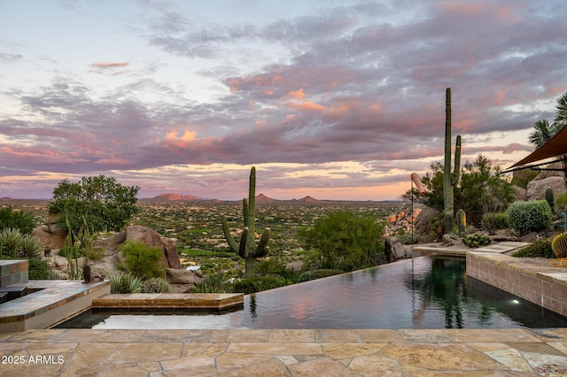 pool at dusk with a mountain view