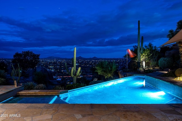 view of pool at dusk