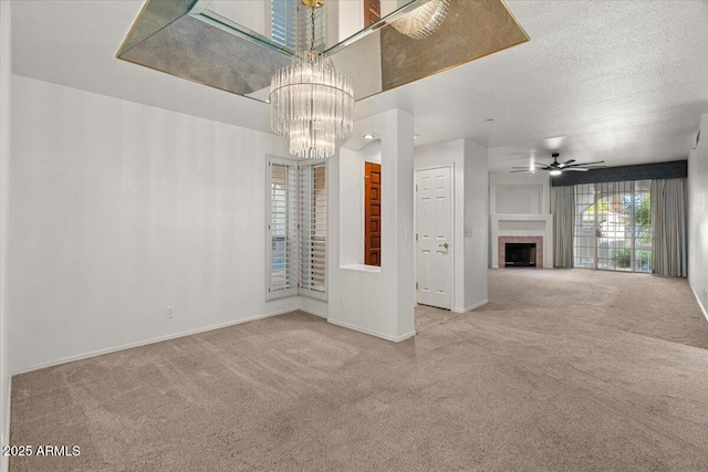 5200 S Lakeshore Dr Unit 120, Tempe, AZ 85283 - unfurnished living room with carpet floors, a chandelier, a fireplace, and baseboards