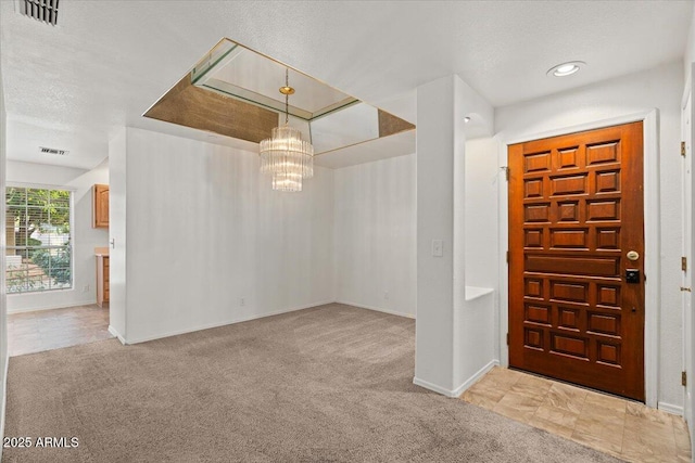5200 S Lakeshore Dr Unit 120, Tempe, AZ 85283 - carpeted entrance foyer with a chandelier, baseboards, and a textured ceiling