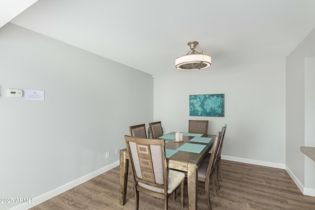 dining area with wood finished floors and baseboards