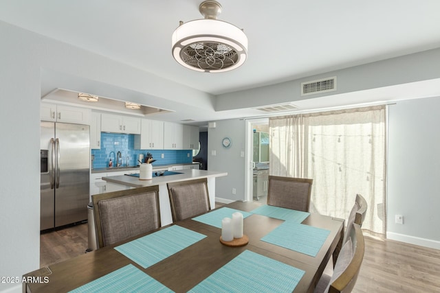 dining room with light wood-style flooring and baseboards