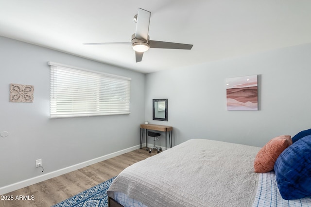 bedroom with wood finished floors, baseboards, and ceiling fan