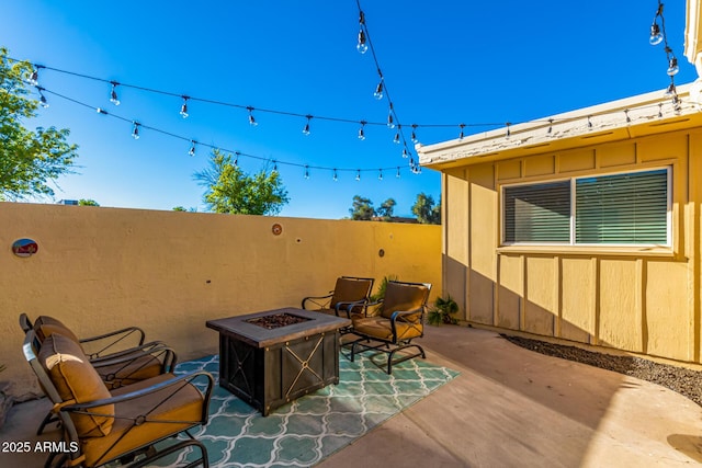 view of patio with an outdoor fire pit and fence