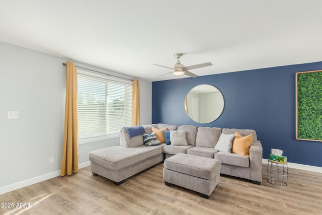 living room featuring wood finished floors, ceiling fan, and baseboards