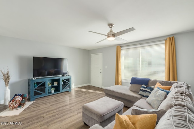 living room with a ceiling fan, wood finished floors, and baseboards