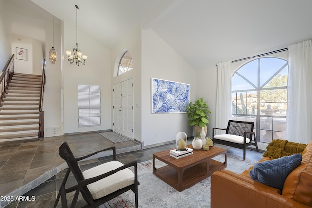 living room featuring high vaulted ceiling and a chandelier