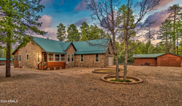 view of front facade featuring an outdoor structure and a garage