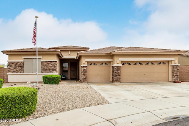 18247 N 168th Cir, Surprise, AZ 85374 - prairie-style home with stucco siding, stone siding, an attached garage, and driveway