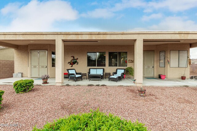 18247 N 168th Cir, Surprise, AZ 85374 - rear view of house with stucco siding, outdoor lounge area, and a patio