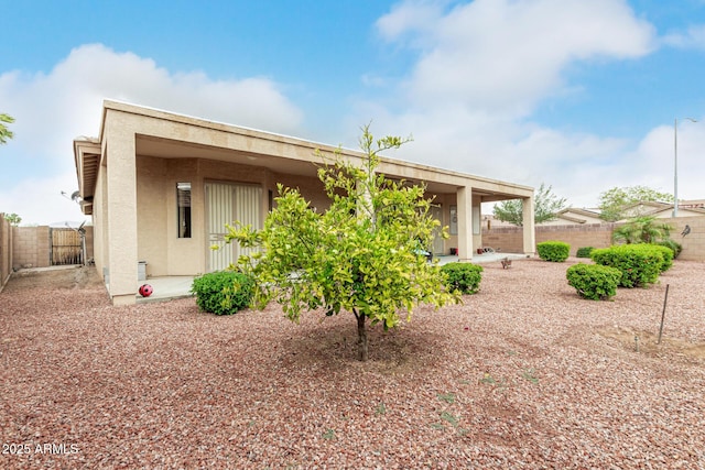 18247 N 168th Cir, Surprise, AZ 85374 - rear view of house with a fenced backyard, stucco siding, a gate, and a patio area