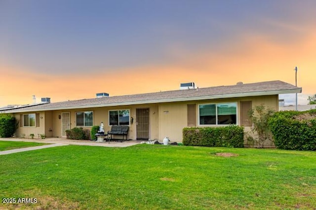 11122 W Desert Butte Dr, Sun City, AZ 85351 - ranch-style house featuring a patio and a front lawn