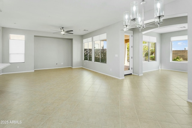 interior space with ceiling fan with notable chandelier and light tile patterned floors