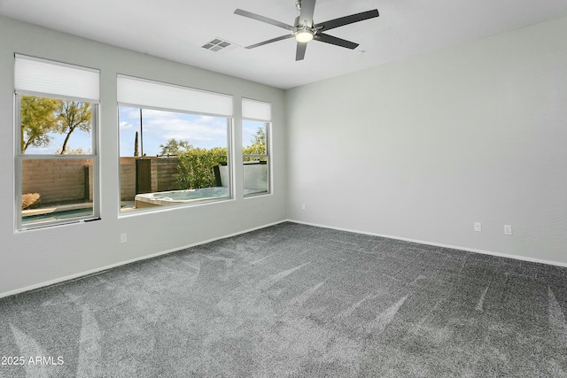 carpeted spare room with ceiling fan