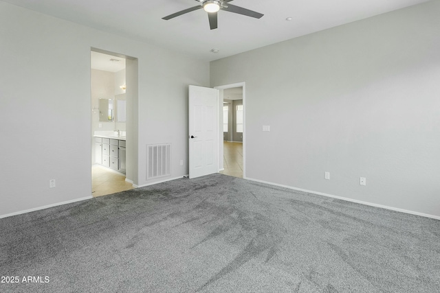 unfurnished room featuring light colored carpet and ceiling fan