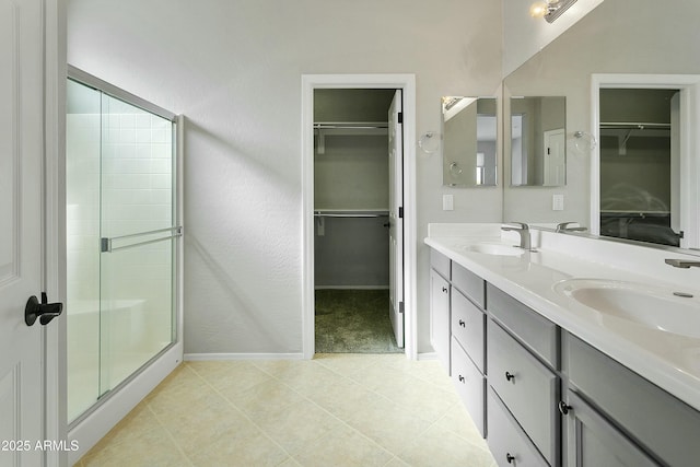 bathroom featuring vanity, tile patterned flooring, and a shower with door