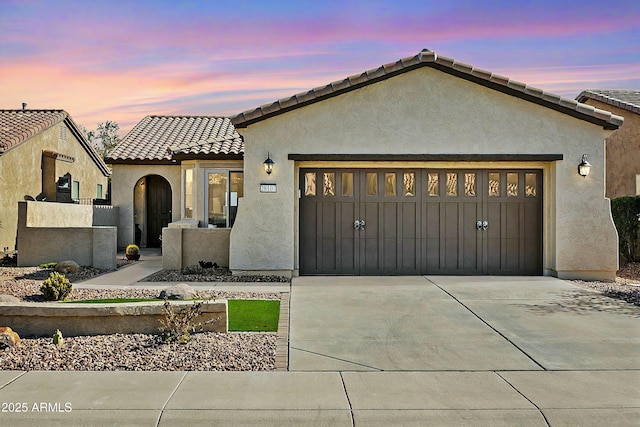 mediterranean / spanish-style home featuring a garage