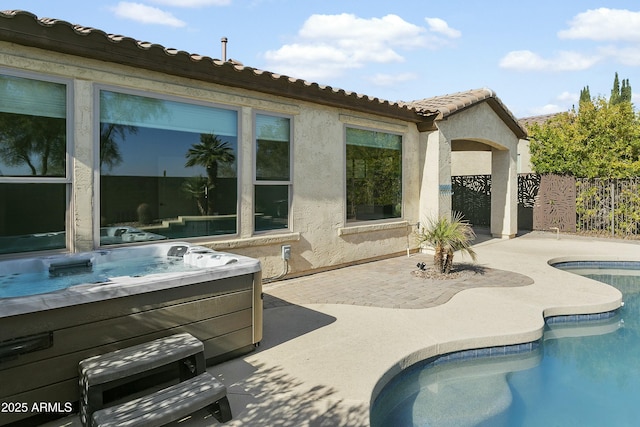 view of swimming pool with a hot tub and a patio area