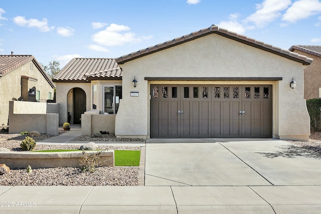 mediterranean / spanish-style house with a garage