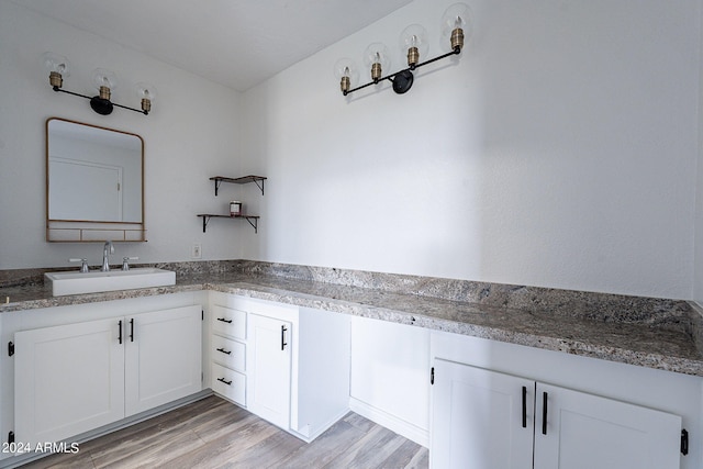 bathroom with vanity and wood-type flooring