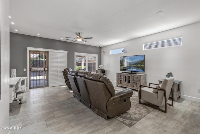 living room featuring a wealth of natural light, recessed lighting, a ceiling fan, and baseboards