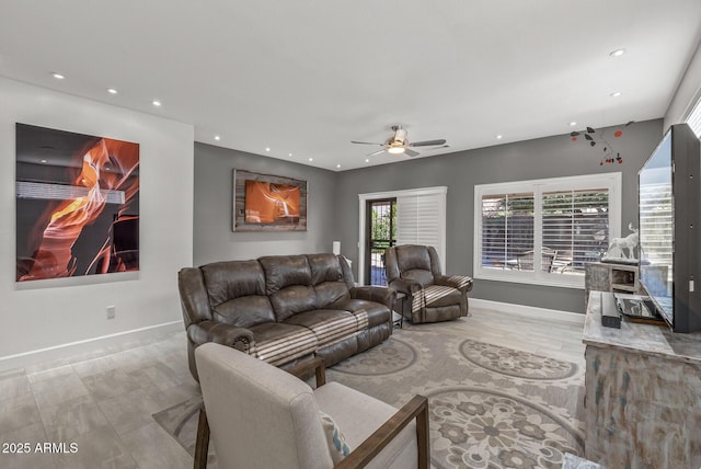 living area featuring recessed lighting and baseboards