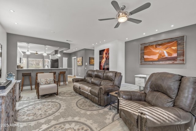 living room with recessed lighting, baseboards, and ceiling fan