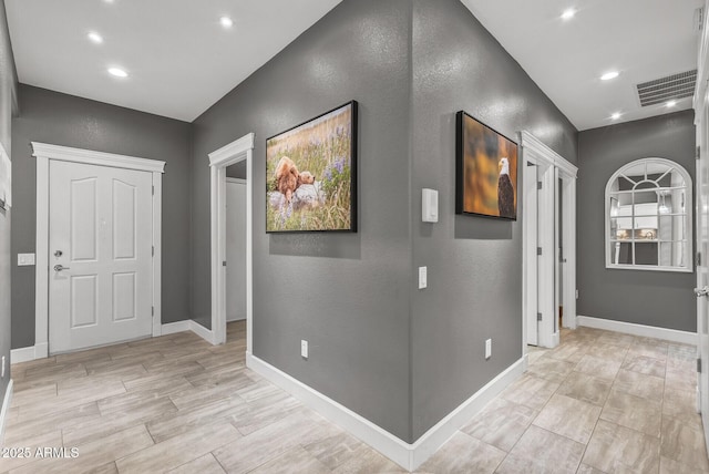 hall featuring recessed lighting, visible vents, and baseboards